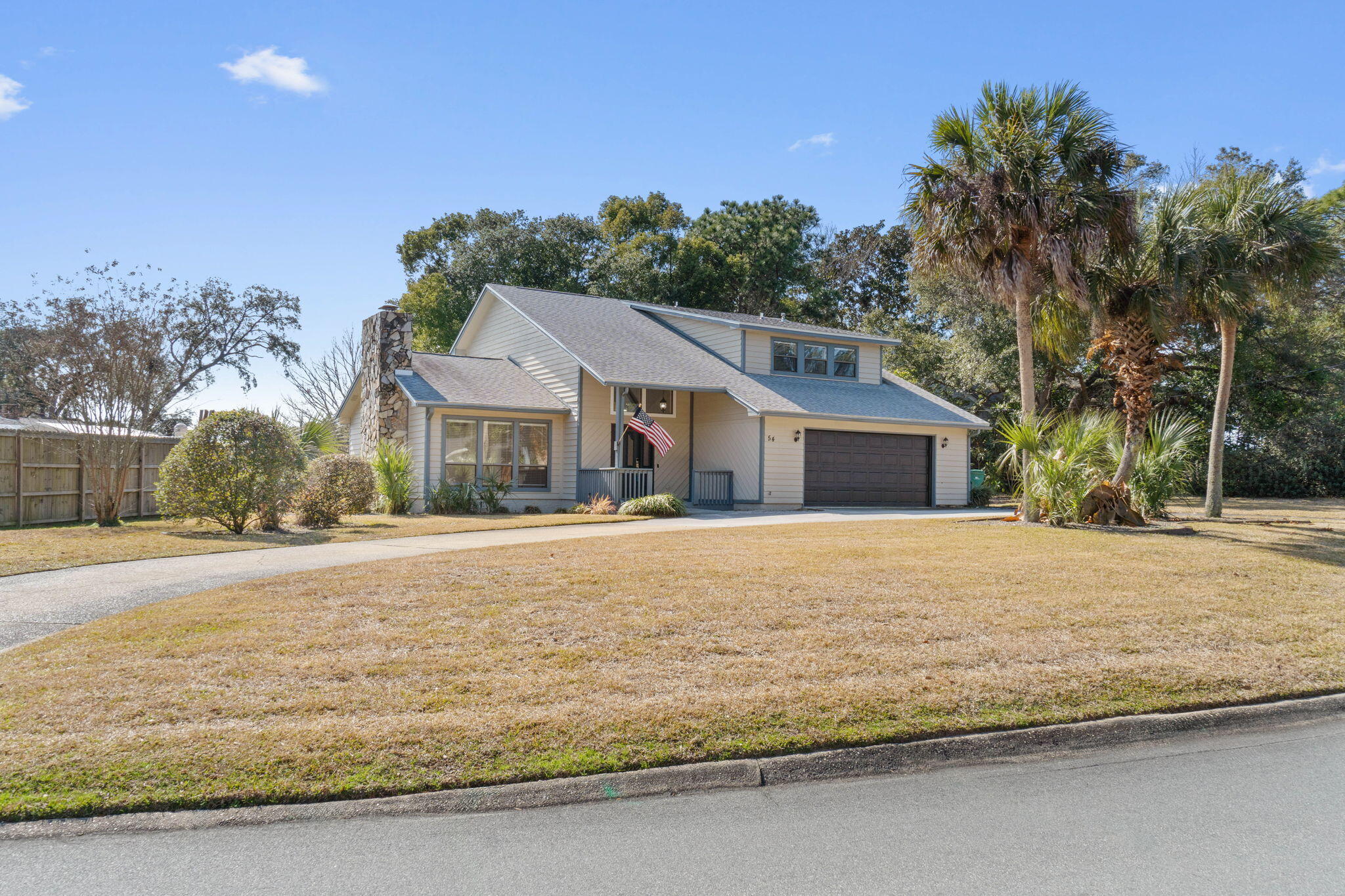 54 Country Club Road Shalimar, FL 32579 - Photo 38 of 58 a front view of house with yard and trees in the background