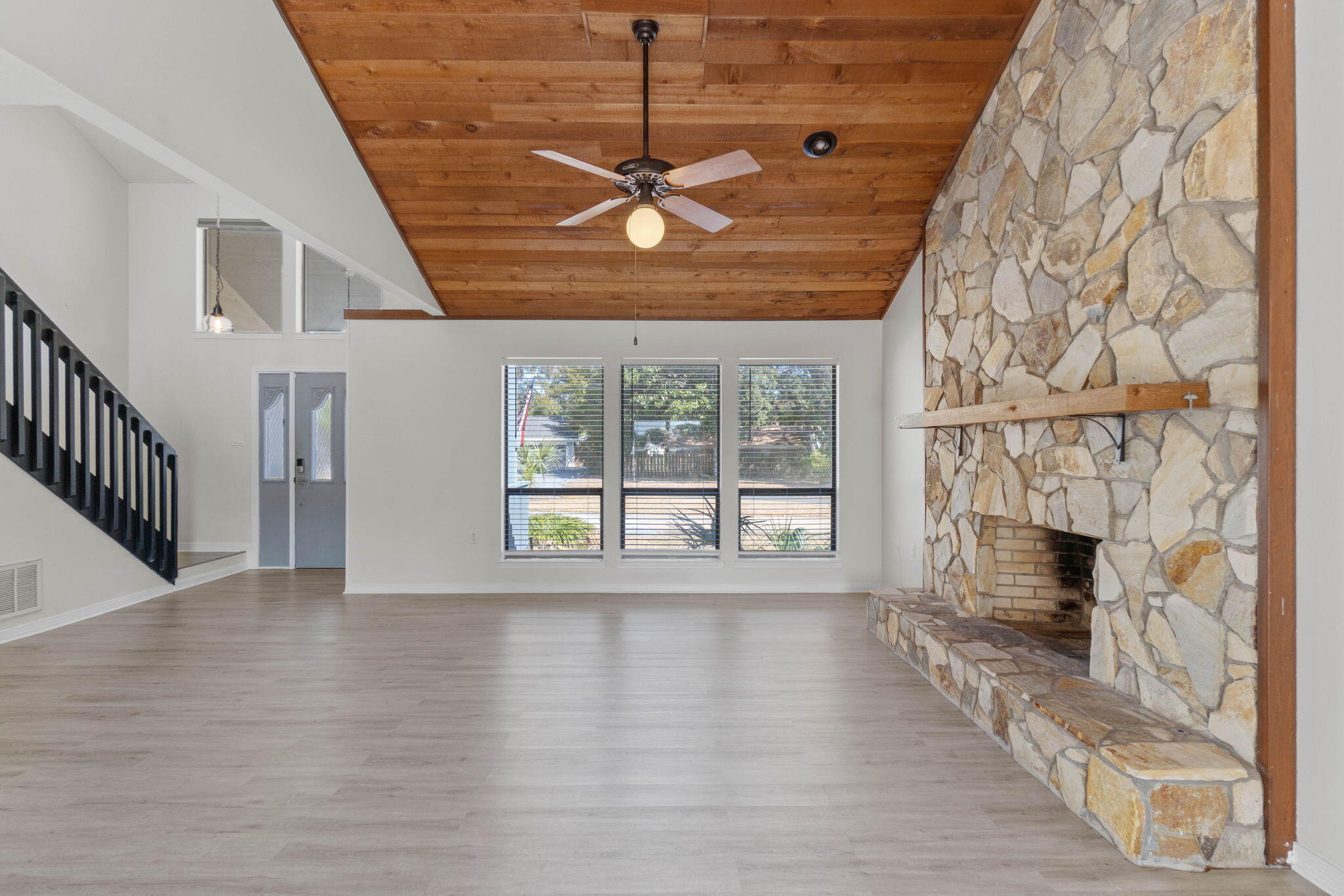 54 Country Club Road Shalimar, FL 32579 - Photo 7 of 58 a view of an empty room with wooden floor and a fireplace