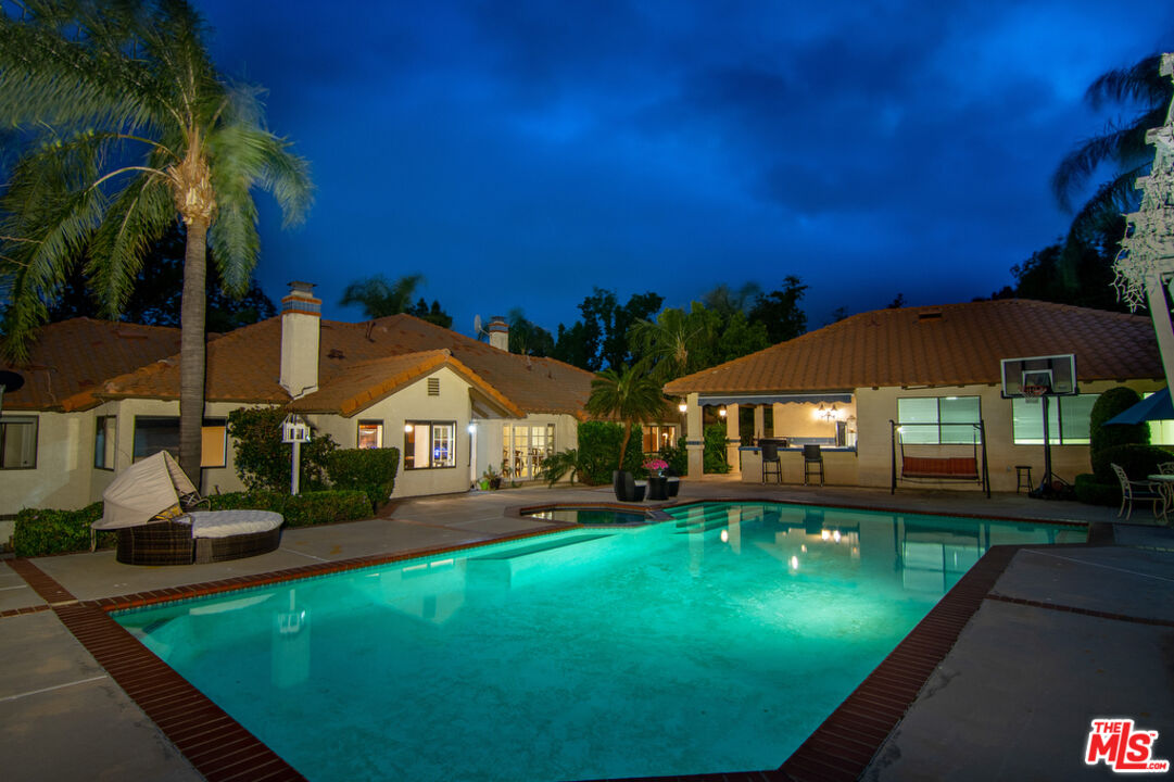 10560 Boulder Canyon Road Rancho Cucamonga, CA 91737 - Photo 23 of 30 a front view of a house with swimming pool having outdoor seating
