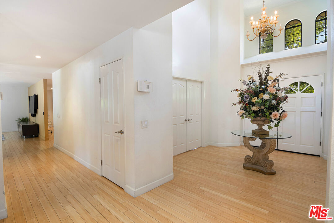 10560 Boulder Canyon Road Rancho Cucamonga, CA 91737 - Photo 6 of 30 a view of a hallway with wooden floor and a potted plant