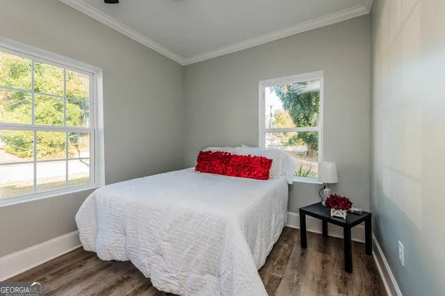 a bathroom with a sink a toilet and bathtub with mirror