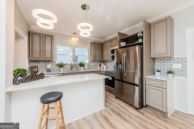 a kitchen with kitchen island granite countertop a sink a counter space appliances and cabinets