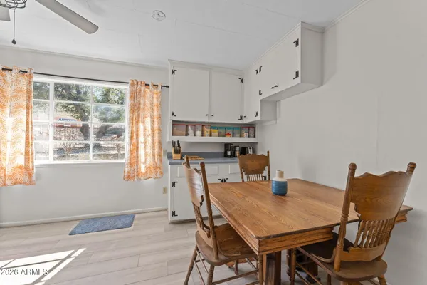 a view of a dining room with furniture and a window