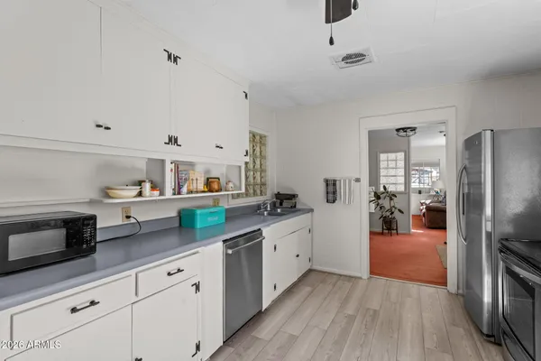 a kitchen with stainless steel appliances granite countertop a refrigerator and a sink
