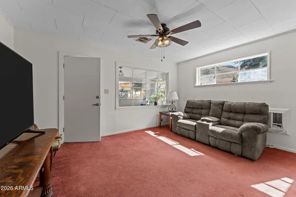 a living room with furniture and a flat screen tv
