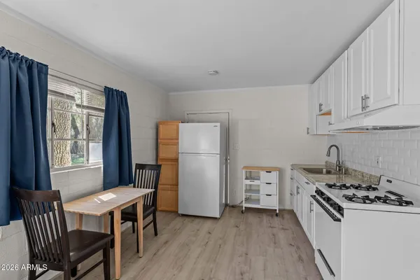a kitchen with a stove a sink and a refrigerator