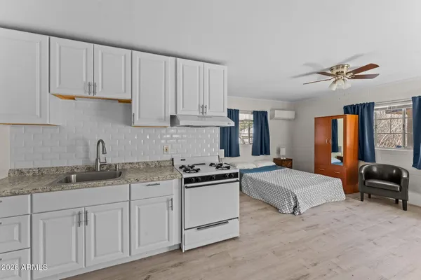 a kitchen with stainless steel appliances granite countertop a sink and cabinets