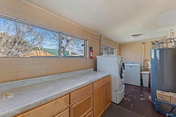a view of a kitchen with refrigerator and window