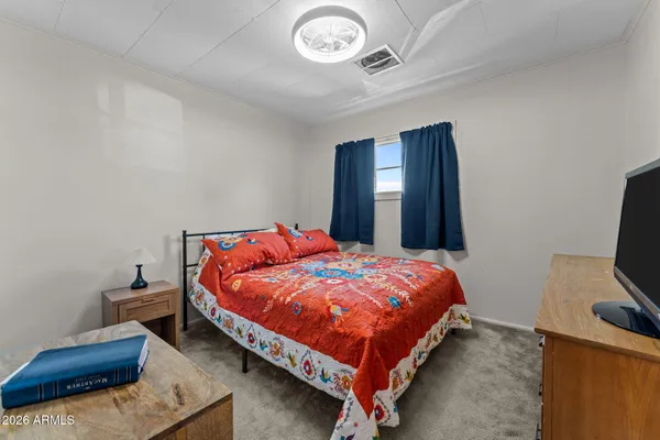 a bed sitting in a bedroom next to a window