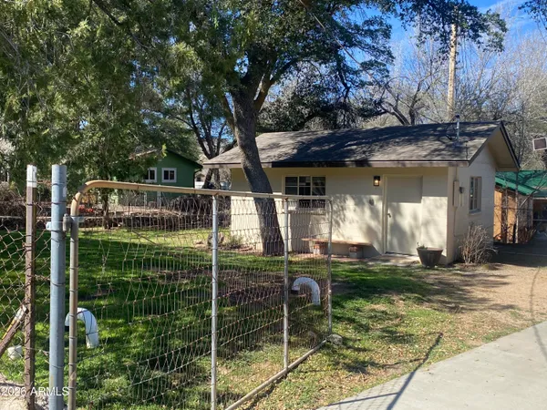 a view of a house with a yard fire pit and furniture