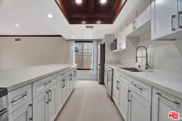 a kitchen with white cabinets