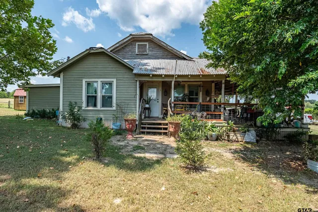 a front view of house with a garden
