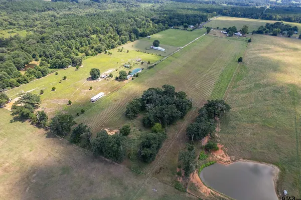a bedroom with furniture and large windows