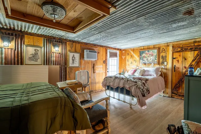 a bedroom with bed and a mirror