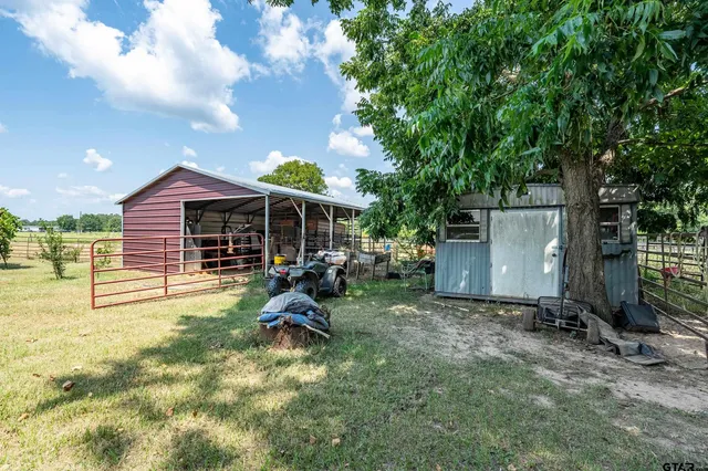 a view of an house with backyard space and garden