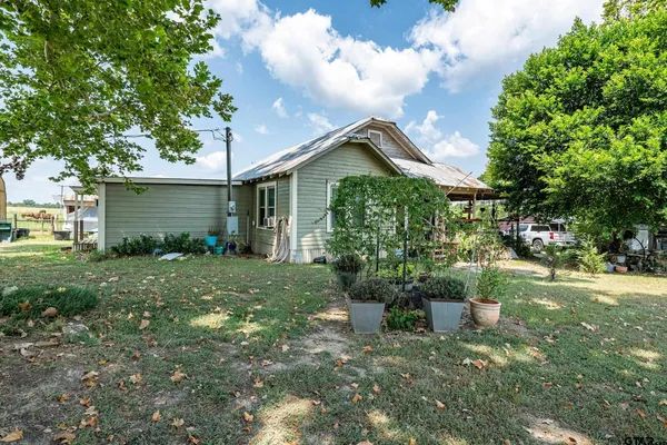a view of house with backyard space and garden
