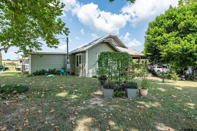 a view of house with backyard space and garden