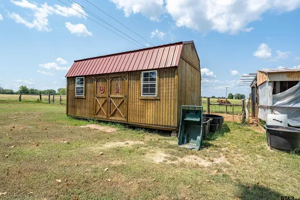 a view of a house with backyard space and sitting area