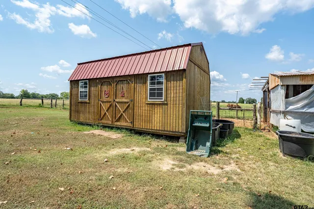 a view of a house with backyard space and sitting area