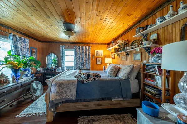 a bed sitting in a bedroom next to a window