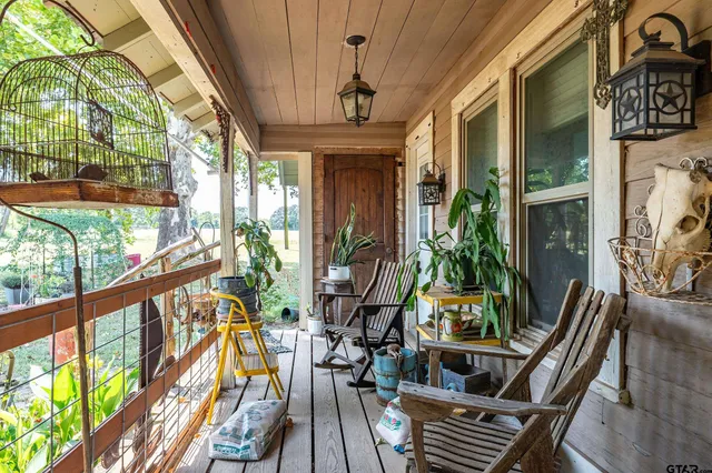 a view of a house with a yard and sitting area