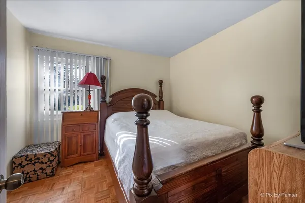 a bedroom with a bed and a chandelier