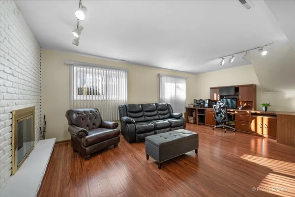 a living room with furniture fireplace and flat screen tv