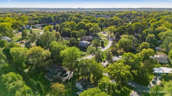 a backyard of a house with lots of green space and fountain