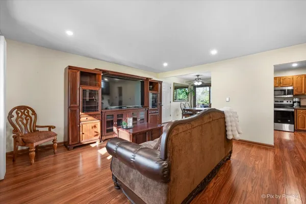 a living room with furniture and a wooden floor
