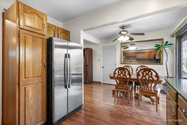 a kitchen with granite countertop stainless steel appliances a dining table chairs and granite counter tops