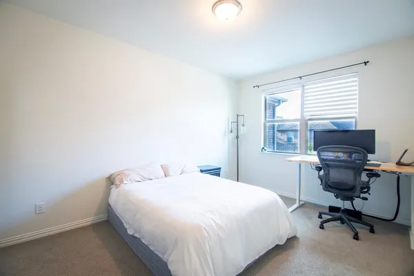 a bedroom with a bed and a desk