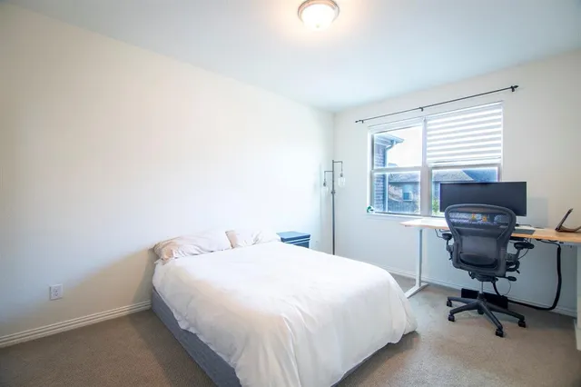 a bedroom with a bed and a desk