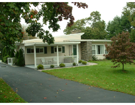 130 Uxbridge Road Sutton, MA 01590 - Photo 1 of 1 a front view of a house with a garden
