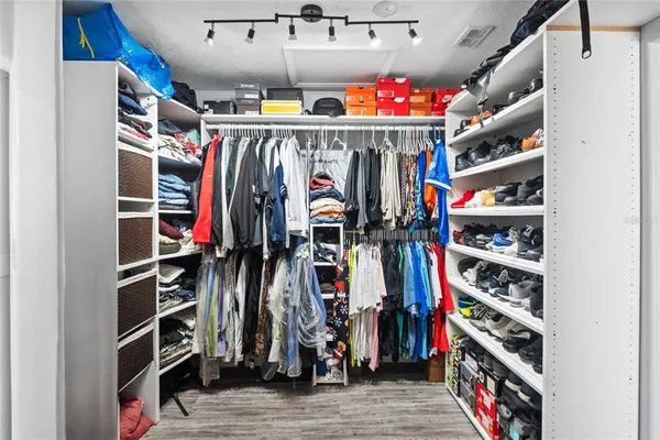 a view of walk in closet with clothes