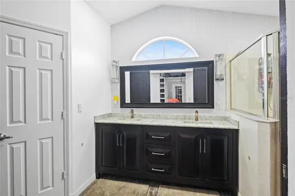a bathroom with a granite countertop sink vanity and a mirror