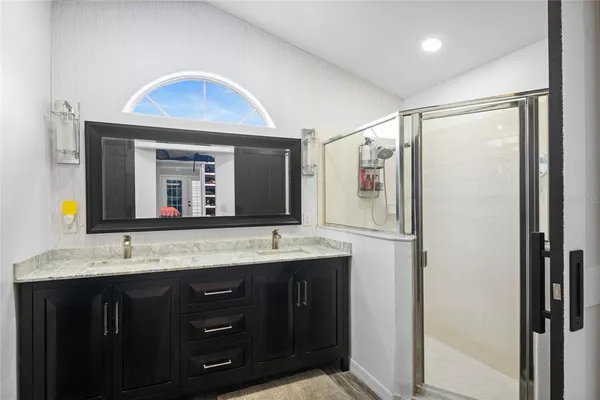 a bathroom with a double vanity sink and mirror