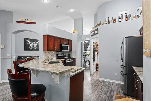 a kitchen with stainless steel appliances a refrigerator stove and sink