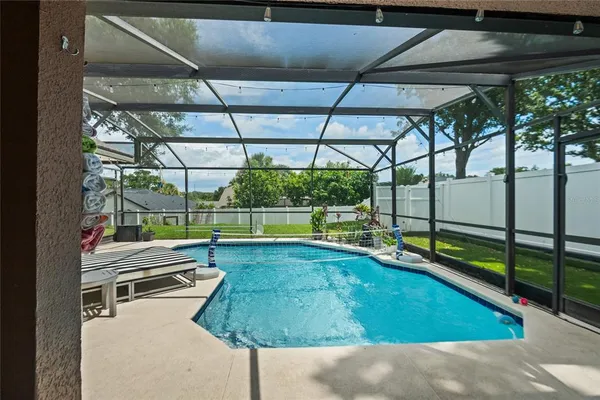 a view of swimming pool with a patio and a yard