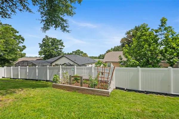 a backyard of a house with table and chairs