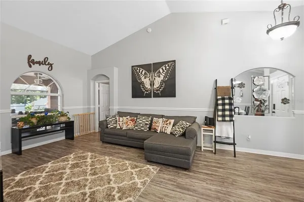 a bedroom with furniture and wooden floor