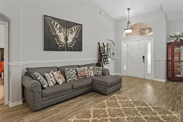 a living room with furniture and wooden floor