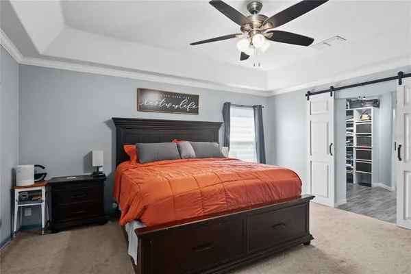 a bedroom with a bed and a desk in it