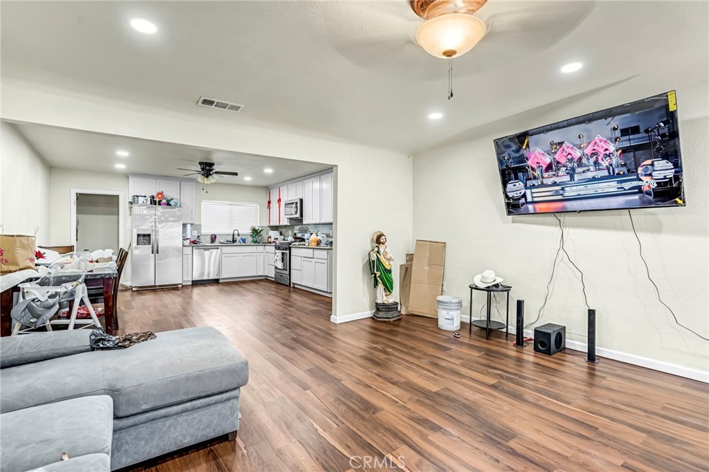 24110 Ave 14 Madera, CA 93637 - Photo 13 of 43 a living room with furniture and a flat screen tv