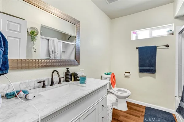 a bathroom with a sink toilet and a mirror