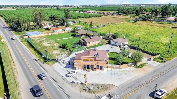an aerial view of a residential houses with outdoor space and street view