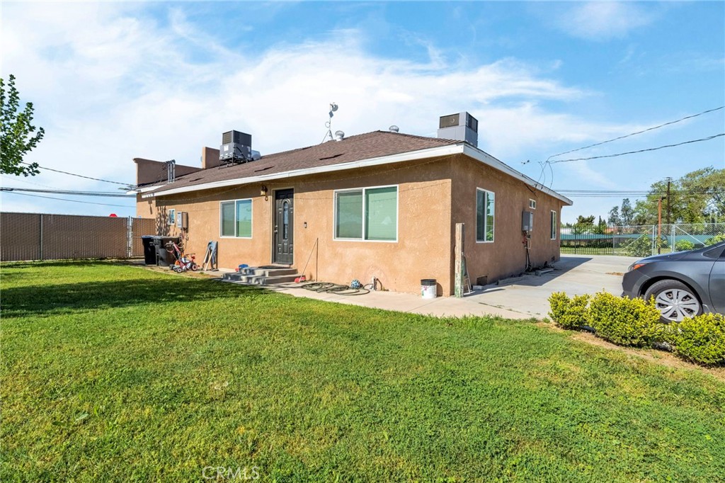24110 Ave 14 Madera, CA 93637 - Photo 21 of 43 a front view of a house with a garden