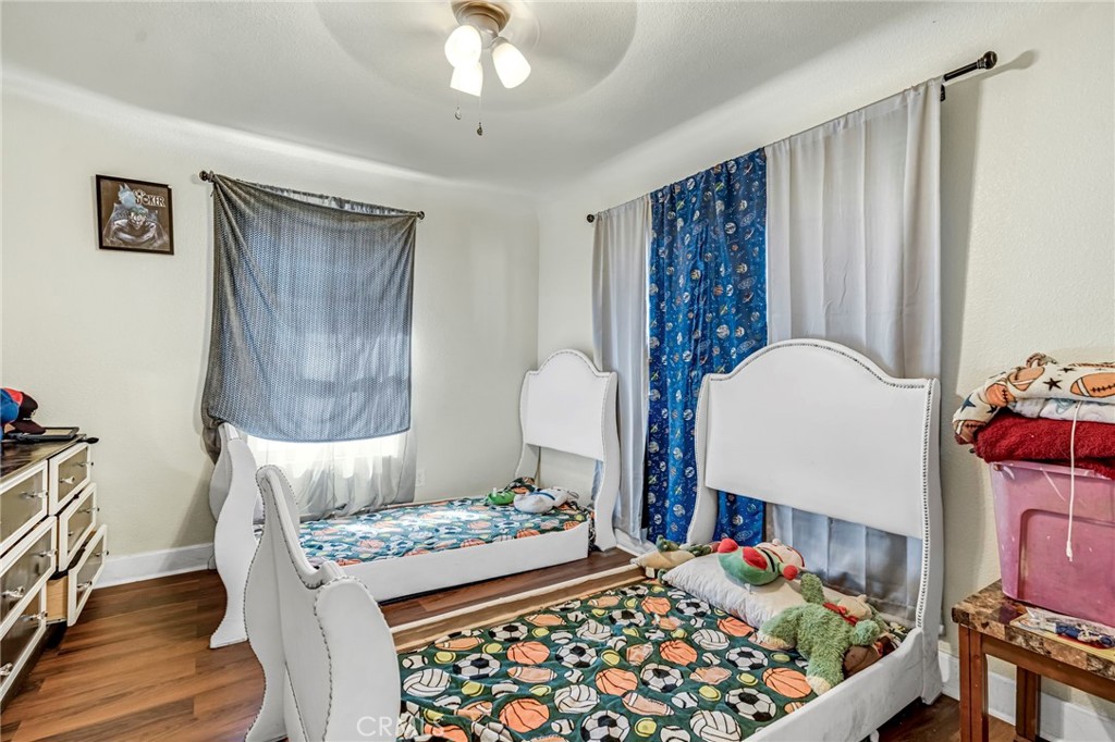 24110 Ave 14 Madera, CA 93637 - Photo 26 of 43 a bedroom with a bed and a window