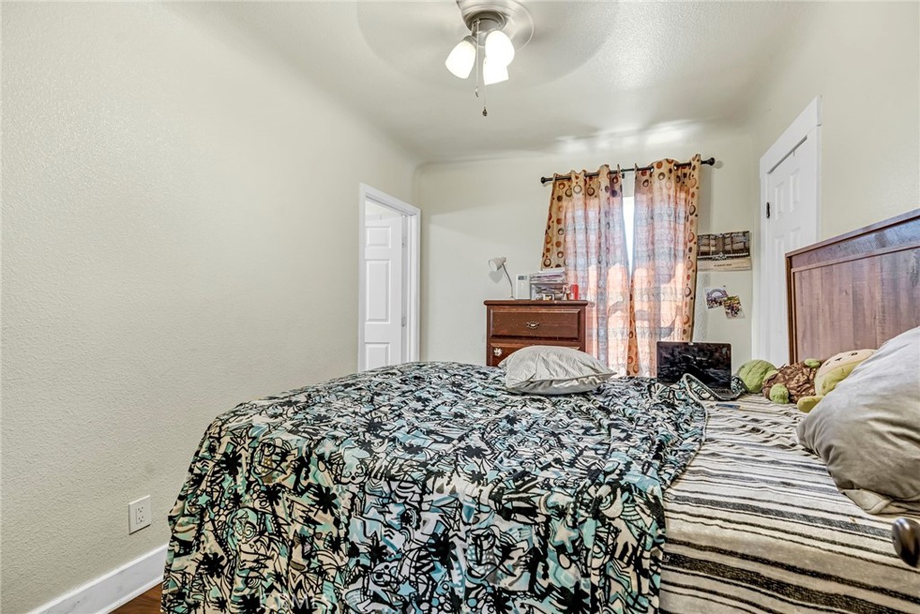 24110 Ave 14 Madera, CA 93637 - Photo 29 of 43 a bedroom with a bed and a chandelier