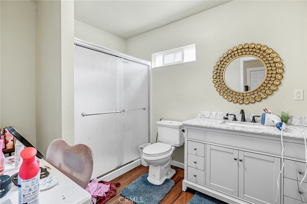 24110 Ave 14 Madera, CA 93637 - Photo 30 of 43 a bathroom with a toilet sink vanity and mirror
