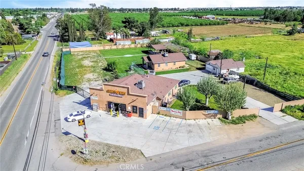 an aerial view of a house with a garden and lake view
